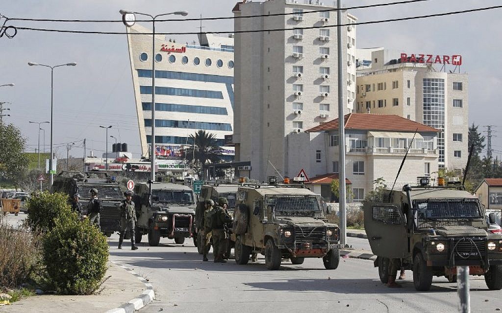 Israeli soldiers deploy during clashes in the West Bank city of Ramallah following a raid on December 10, 2018, one day after a drive-by terror shooting attack next to an Israeli settlement. (Abbas Momani/AFP)