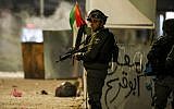 An Israeli border guard stands during clashes with Palestinian protesters in the West Bank city of Ramallah on December 11, 2018.  (ABBAS MOMANI / AFP)