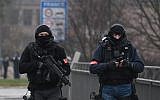 Two members of the French police unit BRI (Research and Intervention Brigade - Brigades de recherche et d'intervention) walk on the Pont de l'Europe, crossing the border with Germany over the river Rhine in Strasbourg, December 12, 2018. (Frederick FLORIN/AFP)