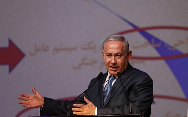 Prime Minister Benjamin Netanyahu gestures as he speaks the Government Press Office's annual New Year's toast in Jerusalem on December 12, 2018. (Gali Tibbon/AFP) Prime Minister Benjamin Netanyahu gestures as he speaks the Government Press Office's annual New Year's toast in Jerusalem on December 12, 2018. (Gali Tibbon/AFP)