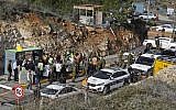 Israeli security forces and forensic experts inspect the scene of a terror shooting outside the Givat Assaf settlement outpost, northeast of the West Bank city of Ramallah, on December 13, 2018. (Ahmad Gharabli/AFP)