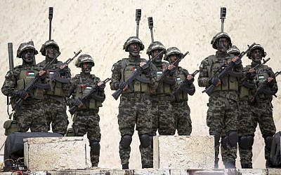 Palestinian fighters from Izz ad-Din al-Qassam Brigades, the military wing of the Hamas terror organization, attend a rally in Gaza City on December 16, 2018, marking the 31st anniversary of the Islamist group's founding. (Said Khatib/AFP)