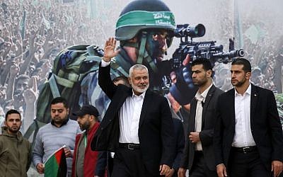 Hamas leader Ismail Haniyeh (3rd-R) waves upon his arrival at a rally marking the 31st anniversary of the terror group's founding, in Gaza City December 16, 2018. (Said Khatib/ AFP)