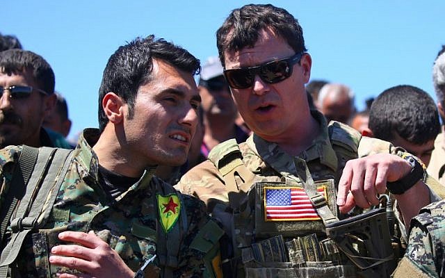 A file photo taken on April 25, 2017, shows a US military officer (R) speaking with a fighter from the Kurdish People's Protection Units (YPG) at the site of Turkish airstrikes near the northeastern Syrian Kurdish town of Derik, known as al-Malikiyah in Arabic. (Delil Souleiman/AFP) A file photo taken on April 25, 2017, shows a US military officer (R) speaking with a fighter from the Kurdish People's Protection Units (YPG) at the site of Turkish airstrikes near the northeastern Syrian Kurdish town of Derik, known as al-Malikiyah in Arabic. (Delil Souleiman/AFP)