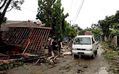 Residents inspect the damage to their homes on Carita beach, Indonesia, on December 23, 2018, after the area was hit by a tsunami on December 22 triggered by an eruption of the Anak Krakatoa volcano, which killed dozens and injured hundreds more as it slammed without warning into tourist beaches and coastal areas around Sunda Strait, sending panicked holiday makers and residents fleeing. (Semi/AFP)