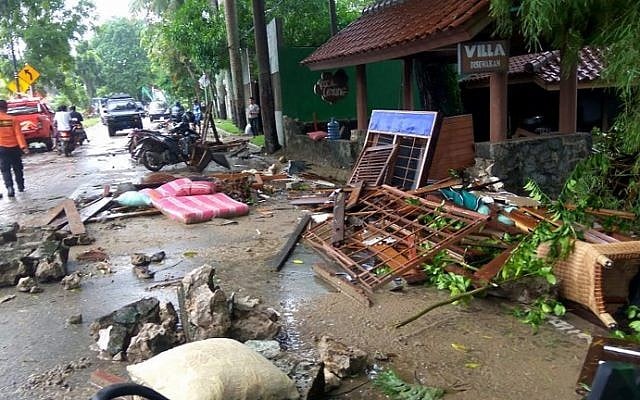 Debris from damaged buildings is seen on a street on Carita beach, Indonesia, on December 23, 2018, after the area was hit by a tsunami on December 22 triggered by an eruption of the Anak Krakatoa volcano, which killed dozens and injured hundreds more as it slammed without warning into tourist beaches and coastal areas around Sunda Strait, sending panicked holiday makers and residents fleeing. (Ronald/AFP) Debris from damaged buildings is seen on a street on Carita beach, Indonesia, on December 23, 2018, after the area was hit by a tsunami on December 22 triggered by an eruption of the Anak Krakatoa volcano, which killed dozens and injured hundreds more as it slammed without warning into tourist beaches and coastal areas around Sunda Strait, sending panicked holiday makers and residents fleeing. (Ronald/AFP)