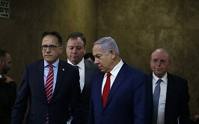 Prime Minister Benjamin Netanyahu (2nd-R) arrives for the weekly cabinet meeting at the Prime Minister's office in Jerusalem on December 23, 2018. (RONEN ZVULUN / AFP)