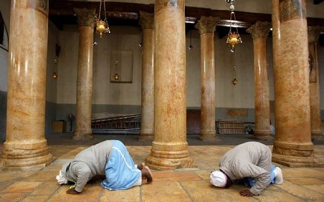 Worshippers pray inside the Church of the Nativity in the biblical West Bank city of Bethlehem, on December 24,2018. (HAZEM BADER/AFP) Worshippers pray inside the Church of the Nativity in the biblical West Bank city of Bethlehem, on December 24,2018. (HAZEM BADER/AFP)