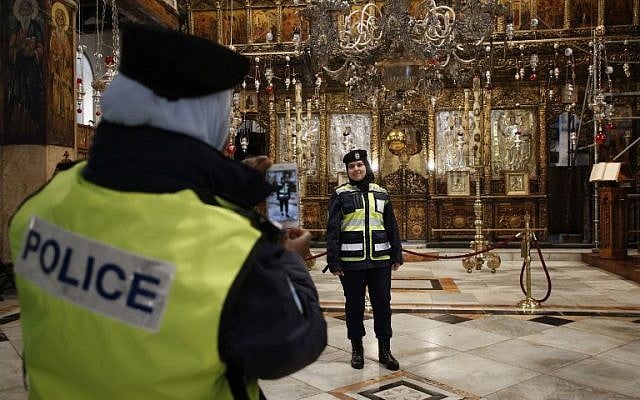 Palestinian female police officers take pictures inside the Church of the Nativity in the biblical West Bank city of Bethlehem, on December 24, 2018. (HAZEM BADER/AFP) Palestinian female police officers take pictures inside the Church of the Nativity in the biblical West Bank city of Bethlehem, on December 24, 2018. (HAZEM BADER/AFP)