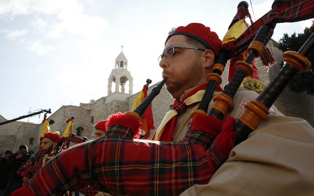 A Palestinian bagpiper blows his instrument as a band performs on Manger square in front of the Church of the Nativity in the biblical West Bank city of Bethlehem, on December 24, 2018. (HAZEM BADER/AFP)