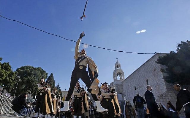 Palestinian bagpipers perform on Manger square in front of the Church of the Nativity in the biblical West Bank city of Bethlehem, on December 24, 2018. (Musa Al SHAER/AFP) Palestinian bagpipers perform on Manger square in front of the Church of the Nativity in the biblical West Bank city of Bethlehem, on December 24, 2018. (Musa Al SHAER/AFP)