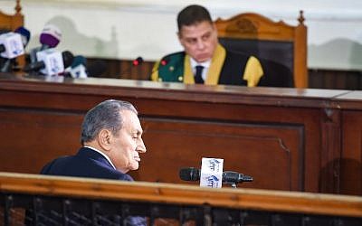 Egyptian judge Mohammed Shirin Fahmi (background) listens to the testimony of former president Hosni Mubarak (front), who was ousted following a popular uprisal in 2011, during a session in the retrial of members of the now-banned Muslim Brotherhood on charges of plotting jailbreaks and attacks on police during the 2011 uprising, at a make-shift courthouse in southern Cairo on December 26, 2018. (Mohamed el-Shahed/AFP)