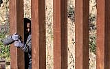 Mexican migrant child Kevin Andres, from Guerrero state, crosses the US-Mexico border fence from Tijuana to San Diego County in the US, as seen from Tijuana, Baja California state, Mexico, on December 28, 2018. (Guillermo Arias / AFP)