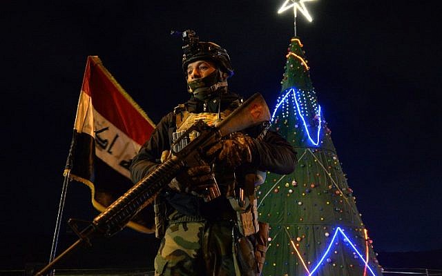 An Iraqi soldier stands guard the street during celebrations for new year's eve in Mosul on December 31, 2018. (Zaid AL-OBEIDI / AFP)