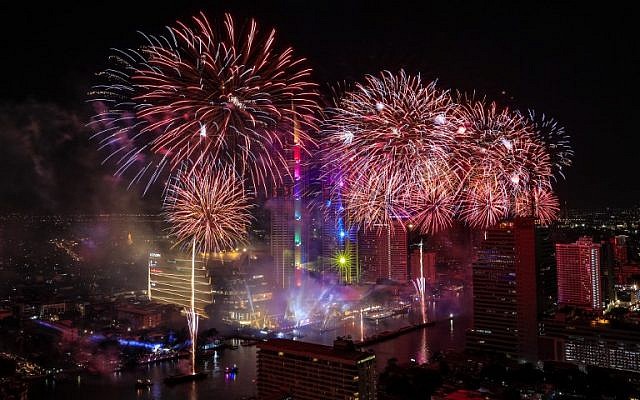 Fireworks explode over the Chao Phraya River during New Year celebrations in Bangkok at the start of January 1, 2019 (Krit Promsakla Na Sakolnakorn / AFP)