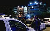 Police at the scene of a shooting in Lod, outside police's national fraud unit (Hadashot TV news screenshot)