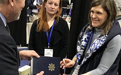 A new facsimile of the 14th-century Sarajevo Hagaddah was on display, and for sale, by the National Museum of Bosnia and Herzegovina in the exhibit hall at the Association of Jewish Studies convention, held in Boston, Mass., Dec. 16-18, 2018. (Penny Schwartz/JTA)