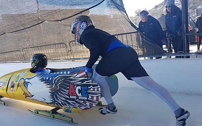 Dave Nicholls, seated, rides in the bobsled. (Courtesy of Nicholls via JTA)