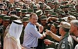 In this Nov. 22, 1990 file photo, President George H.W. Bush is greeted by Saudi troops and others as he arrives in Dhahran, Saudi Arabia, for a Thanksgiving visit (AP Photo/J. Scott Applewhite, File)