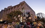 A menorah is tested outside the Tree of Life Synagogue in preparation for a celebration service at sundown on the first night of Hanukkah, December 2, 2018 in the Squirrel Hill neighborhood of Pittsburgh. A gunman shot and killed 11 people while they worshiped at the synagogue on October 27, 2018 at the temple. (AP Photo/Gene J. Puskar)