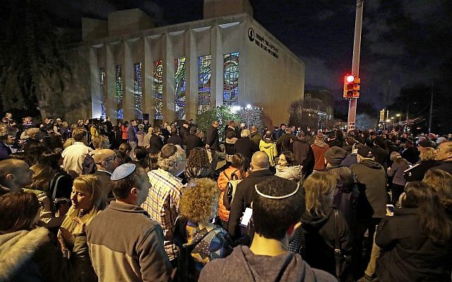 Rabbi Jeffrey Myers leads a gathering in Hanukkah songs after lighting a menorah outside the Tree of Life Synagogue on the first night of Hanukkah, Sunday, Dec. 2, 2018 in the Squirrel Hill neighborhood of Pittsburgh. A gunman shot and killed 11 people while they worshipped Saturday, Oct. 27, 2018 at the temple. (AP Photo/Gene J. Puskar) Rabbi Jeffrey Myers leads a gathering in Hanukkah songs after lighting a menorah outside the Tree of Life Synagogue on the first night of Hanukkah, Sunday, Dec. 2, 2018 in the Squirrel Hill neighborhood of Pittsburgh. A gunman shot and killed 11 people while they worshipped Saturday, Oct. 27, 2018 at the temple. (AP Photo/Gene J. Puskar)