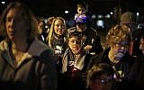 Illustrative: People watch as a menorah is lighted outside the Tree of Life Synagogue on the first night of Hanukkah, December 2, 2018 in the Squirrel Hill neighborhood of Pittsburgh. (AP Photo/Gene J. Puskar)