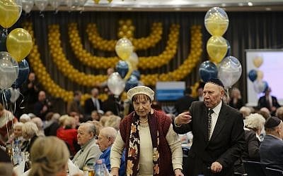 Two holocaust survivors arrive for Hanukkah candlelighting at the International Holocaust Survivors Night of the Jewish Community in Berlin, Germany, Tuesday, December 4, 2018. (AP Photo/Markus Schreiber)