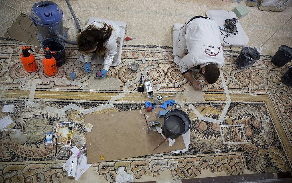 Restoration experts work on a mosaic inside the Church of the Nativity in the West Bank City of Bethlehem, December 6, 2018. (Majdi Mohammed/AP) Restoration experts work on a mosaic inside the Church of the Nativity in the West Bank City of Bethlehem, December 6, 2018. (Majdi Mohammed/AP)