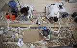Restoration experts work on a mosaic inside the Church of the Nativity in the West Bank City of Bethlehem, December 6, 2018. (Majdi Mohammed/AP)