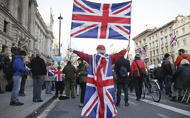 Demonstrators hold placards and flags at the 'Brexit Betrayal Rally,' a pro-Brexit rally, on Whitehall in London, December 9, 2018. (Tim Ireland/AP) Demonstrators hold placards and flags at the 'Brexit Betrayal Rally,' a pro-Brexit rally, on Whitehall in London, December 9, 2018. (Tim Ireland/AP)