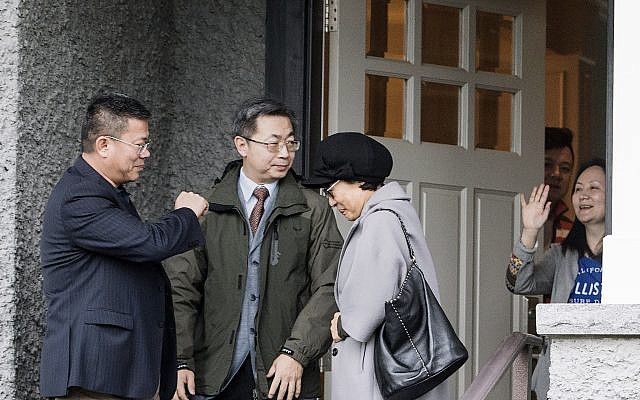 Huawei chief financial officer Meng Wanzhou, right, waves goodbye to visitors at her home in Vancouver on December 12, 2018. (Jonathan Hayward/The Canadian Press via AP) Huawei chief financial officer Meng Wanzhou, right, waves goodbye to visitors at her home in Vancouver on December 12, 2018. (Jonathan Hayward/The Canadian Press via AP)