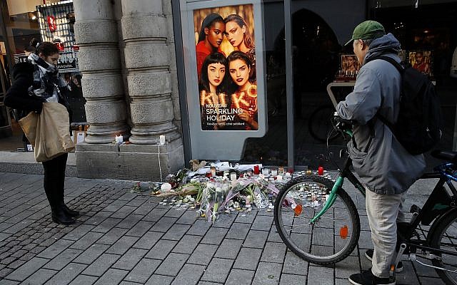People pay respects at the site of a deadly terror attack in Strasbourg, eastern France, two days after the attack, on Thursday, December 13, 2018. (AP Photo/Christophe Ena)