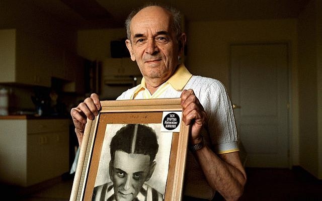 In this 2001 photo, Alter Wiener, born in 1926, holds up a photo of himself taken in July 1945, two months after he was liberated from a Nazi death camp, in his apartment in Aloha, Oregon. (Benjamin Brink/The Oregonian via AP) In this 2001 photo, Alter Wiener, born in 1926, holds up a photo of himself taken in July 1945, two months after he was liberated from a Nazi death camp, in his apartment in Aloha, Oregon. (Benjamin Brink/The Oregonian via AP)