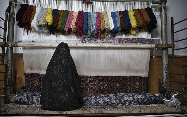 In this photo from December 10, 2018, a woman weaves a Persian carpets at her home in Kashan, Iran. (AP Photo/Vahid Salemi) In this photo from December 10, 2018, a woman weaves a Persian carpets at her home in Kashan, Iran. (AP Photo/Vahid Salemi)