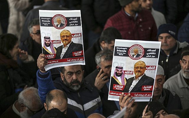 In this photo from November 16, 2018, members of Arab-Turkish Media Association and friends of Washington Post columnist Jamal Khashoggi hold posters showing images of Saudi Crown Prince Muhammed bin Salman and of Khashoggi, as they attend funeral prayers in absentia for him following his killing the previous month in the Saudi Arabia consulate, in Istanbul. (AP Photo/Emrah Gurel, File) In this photo from November 16, 2018, members of Arab-Turkish Media Association and friends of Washington Post columnist Jamal Khashoggi hold posters showing images of Saudi Crown Prince Muhammed bin Salman and of Khashoggi, as they attend funeral prayers in absentia for him following his killing the previous month in the Saudi Arabia consulate, in Istanbul. (AP Photo/Emrah Gurel, File)