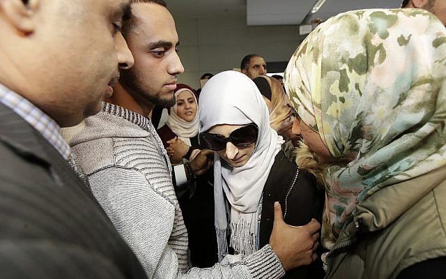 Shaima Swileh, center, stands with her husband Ali Hassan, second from left, after Swileh arrived at San Francisco International Airport in San Francisco on December 19, 2018. (AP Photo/Jeff Chiu) Shaima Swileh, center, stands with her husband Ali Hassan, second from left, after Swileh arrived at San Francisco International Airport in San Francisco on December 19, 2018. (AP Photo/Jeff Chiu)