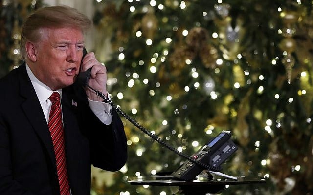 US President Donald Trump speaks on the phone sharing updates to track Santa's movements from the North American Aerospace Defense Command (NORAD) Santa Tracker on Christmas Eve, December 24, 2018. (AP Photo/Jacquelyn Martin)