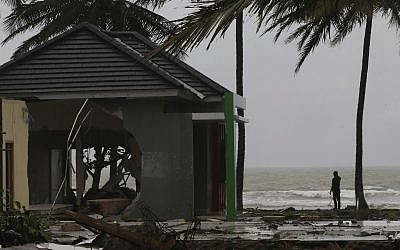 A man stands near the sea in Carita, Indonesia, December 26, 2018. (AP Photo/Achmad Ibrahim)