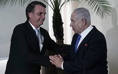 Brazil's President-elect Jair Bolsonaro, left, and Israel's Prime Minister Benjamin Netanyahu shake hands during a joint statement at the military base Fort Copacabana, in Rio de Janeiro, Brazil, Friday, Dec. 28, 2018. (Leo Correa/Pool Photo via AP)
