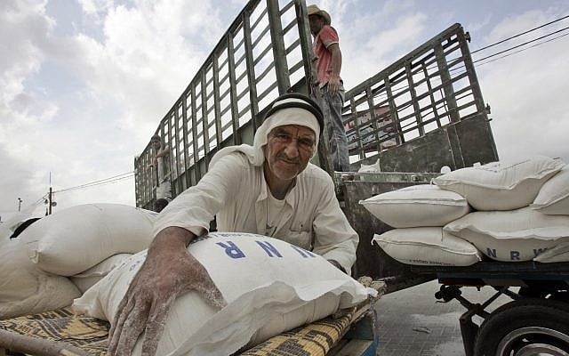 A Palestinian man loads flour bags onto a donkey cart outside the United Nations World Food Programme distribution center in the Rafah refugee camp, southern Gaza Strip, Nov. 7, 2007 (AP Photo/Khalil Hamra) A Palestinian man loads flour bags onto a donkey cart outside the United Nations World Food Programme distribution center in the Rafah refugee camp, southern Gaza Strip, Nov. 7, 2007 (AP Photo/Khalil Hamra)