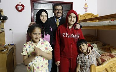 In this May 7, 2009 file photo, Palestinian Dr. Izzeldin Abuelaish poses for a picture with his children in his house in Jebaliya, northern Gaza Strip. (AP Photo/Khalil Hamra, File)