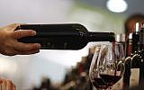 Illustrative: A man pours a glass of red wine at the annual International Wine and Spirits Exhibition 'Vinitaly,' in Verona, northern Italy, on April 8, 2010. (AP Photo/Luca Bruno)