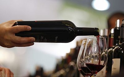 Illustrative: A man pours a glass of red wine at the annual International Wine and Spirits Exhibition 'Vinitaly,' in Verona, northern Italy, on April 8, 2010. (AP Photo/Luca Bruno)
