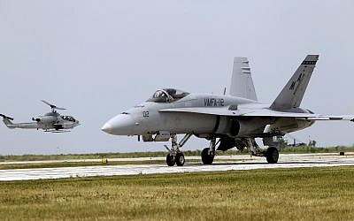 Illustrative: A Marine F-18 "Super Hornet" taxies as a AH-1 Cobra helicopter lands at Burke Lakefront Airport in Cleveland Saturday, June 16, 2012 as part of Marine Week in the city. (AP Photo/Mark Duncan) Illustrative: A Marine F-18 "Super Hornet" taxies as a AH-1 Cobra helicopter lands at Burke Lakefront Airport in Cleveland Saturday, June 16, 2012 as part of Marine Week in the city. (AP Photo/Mark Duncan)