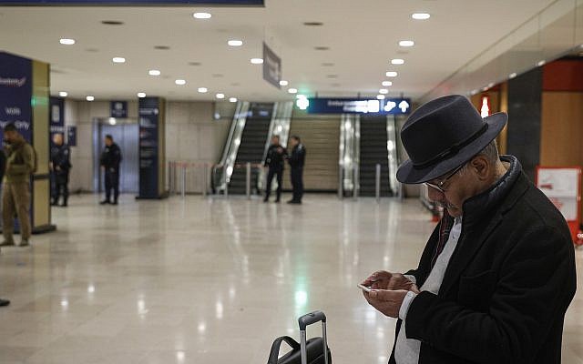A traveler checks his smartphone inside Orly airport, south of Paris March, 18, 2017. AP Photo/Kamil Zihnioglu) A traveler checks his smartphone inside Orly airport, south of Paris March, 18, 2017. AP Photo/Kamil Zihnioglu)