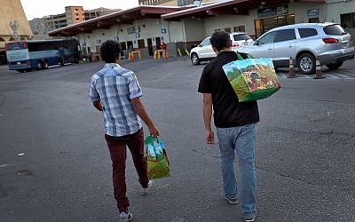 Wilson Romero, left, and Daniel Montes, both from Honduras, arrive at a bus terminal early  June 27, 2018, in El Paso, Texas (AP Photo/Matt York)