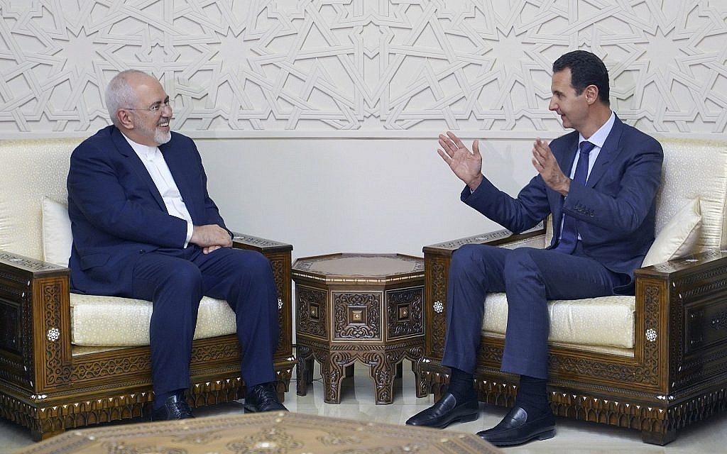 Illustrative: In this photo released by the Syrian official news agency SANA, Syrian President Bashar Assad, right, speaks with Iranian Foreign Minister Mohammad Javad Zarif in Damascus, Syria, Sept 3, 2018. (SANA via AP)