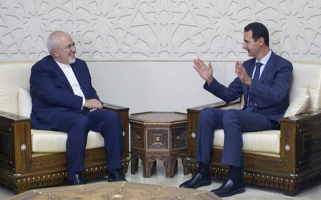Illustrative: In this photo released by the Syrian official news agency SANA, Syrian President Bashar Assad, right, speaks with Iranian Foreign Minister Mohammad Javad Zarif in Damascus, Syria, Sept 3, 2018. (SANA via AP) Illustrative: In this photo released by the Syrian official news agency SANA, Syrian President Bashar Assad, right, speaks with Iranian Foreign Minister Mohammad Javad Zarif in Damascus, Syria, Sept 3, 2018. (SANA via AP)