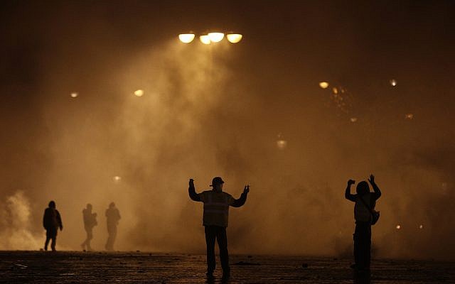 Demonstrators attend a demonstration near the Arc de Triomphe, Dec.1, 2018 in Paris (AP Photo/Kamil Zihnioglu)