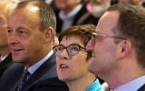In this Wednesday, November 21, 2018 file photo, Friedrich Merz, former German Christian Democratic Union faction leader, left, Annegret Kramp-Karrenbauer, General Secretary of the CDU, and Germany's Health Minister Jens Spahn, right, all members of the CDU, attend a party regional conference candidates for the CDU chairmanship in Seebach, central Germany. (AP Photo/Jens Meyer, file)